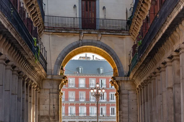 One of the entrance arches that give access to the main square of Madrid with its typical buildings of ancient times, Spain