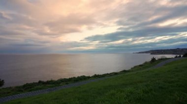 Sakin ve sakin bir günde deniz ufkunun üzerinde altın bir günbatımının insansız hava aracı görüntüsü, Gijon, Asturias.