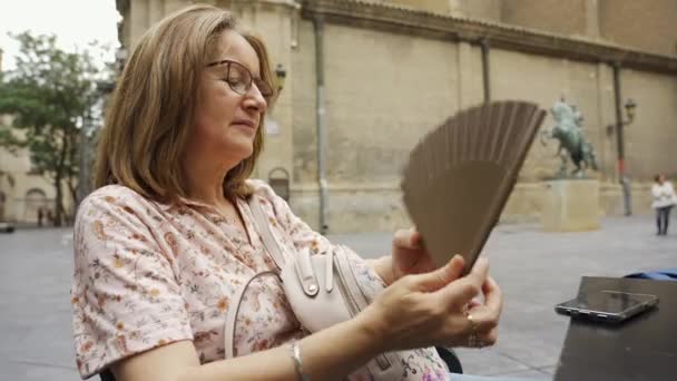 Mujer Madura Con Calor Sentada Fuera Abanicándose Los Efectos Manopausia — Vídeos de Stock