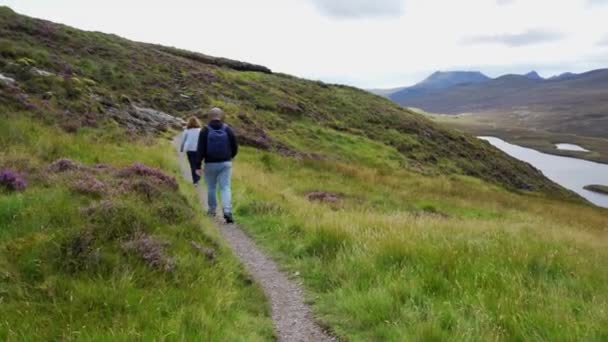 スコットランド スコットランド イギリスの風景でスコットランドの山々をハイキングする男と女 — ストック動画