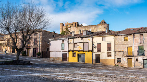 Old houses in the large square of the picturesque village of Palazuelos, Guadalajara, Spain