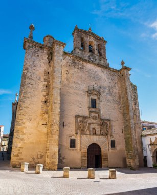 Large medieval church of pieces rising majestically in the main square of Trujillo, Spain clipart