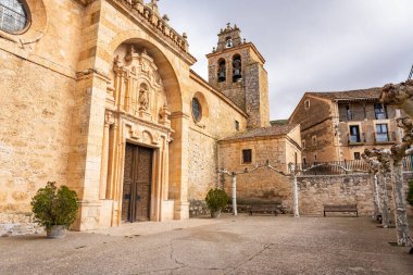 Medieval church facade with tower and bell tower in the old villages of Castilla Leon clipart