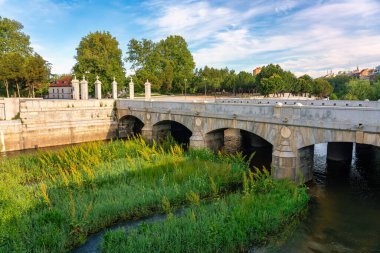 Ancient stone bridge that spans the Manzanares River in Madrid, Spain clipart