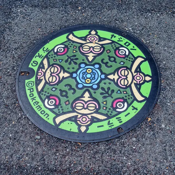 stock image Kurashiki, Japan - April 14, 2024: Pokemon Utility Hole Cover on the floor at Japan, picture focus on Steel manhole cover for drainage