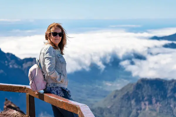 stock image Tourist woman enjoying the stunning views from the top of the mountain, La Palma island, Canary Islands