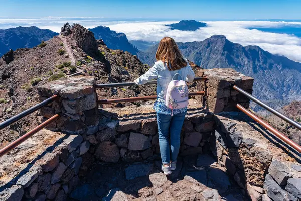 stock image Tourist woman enjoying the breathtaking views from the top of the volcanic mountain, La Palma