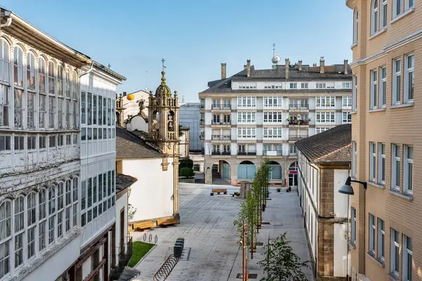 stock image Square inside the old town of Lugo with its white-fronted houses and a very old church, Galicia