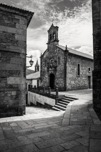 stock image Old stone church with medieval buildings in the city of Tui, black and white photo