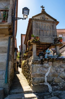 Narrow picturesque streets with stone granaries by the sea of Combarro, Galicia clipart