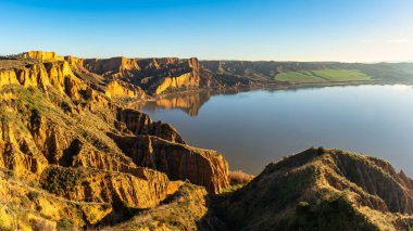 Panoramic view of the Burujon canyon in Toledo, with the eroded ravines next to the lake, Spain clipart