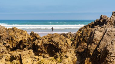 Güneşli bir yaz gününde, Liencres plajının önündeki kaya oluşumları, İspanya