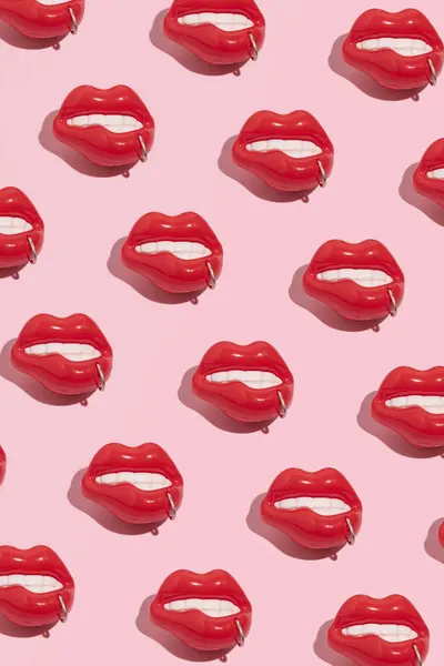 Lip piercing idea, creative pattern against pastel pink background.