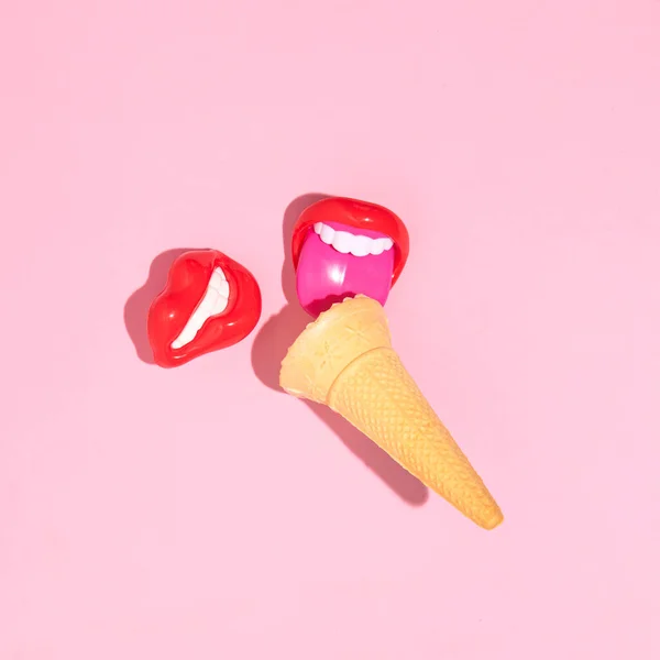 Ice cream cone and girl\'s lips lollipops, creative summer fun concept, candy pink background.