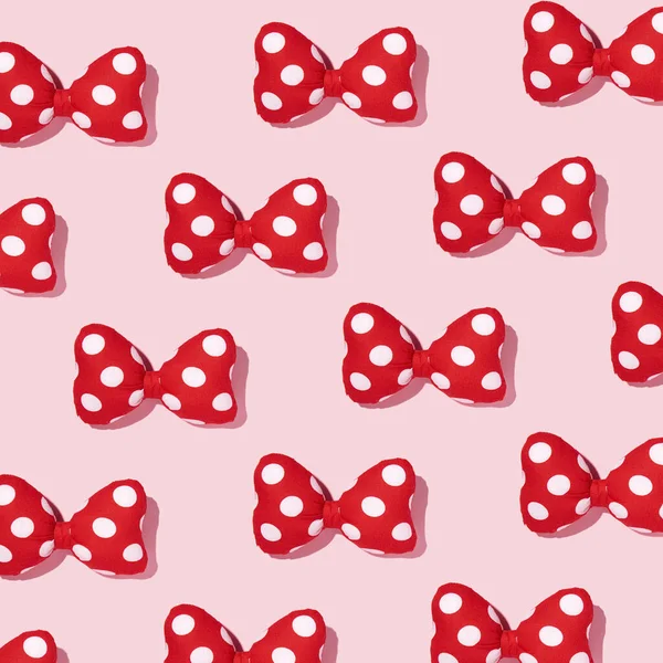 Hair bows, polka dots pattern, retro fashion style pattern, pastel pink background.
