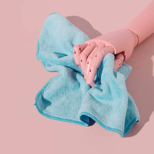 A soft cloth for cleaning and polishing in the hand of a wooden doll, pastel pink and blue aesthetic layout.