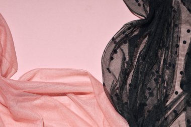Güzel şeffaf kadın kumaşları, pastel pembe ve siyah tül, yaka şekli, yaratıcı estetik arka plan.