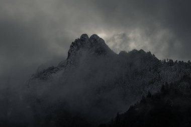 Dramatik bulutlu gökyüzü ile gizemli siyah dağ