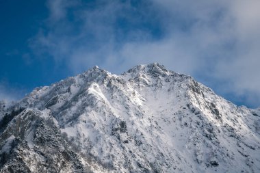 Winter landscape with snow covered trees and road in the middle of forest