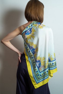 Moda kıyafetleri giyen güzel bir genç kadının portresi. Stüdyo çekimleri beyaz arkaplanda.