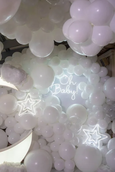 white balloons on a background of a large glass with a lot of confetti