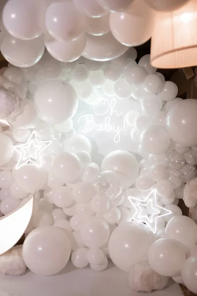 white balloons on a background of a large glass.