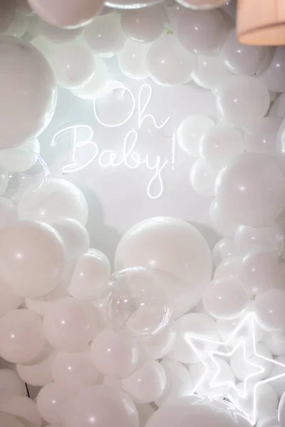white balloons on a background of a garland.