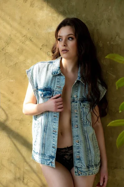 Fashion woman in jeans jacket over naked body