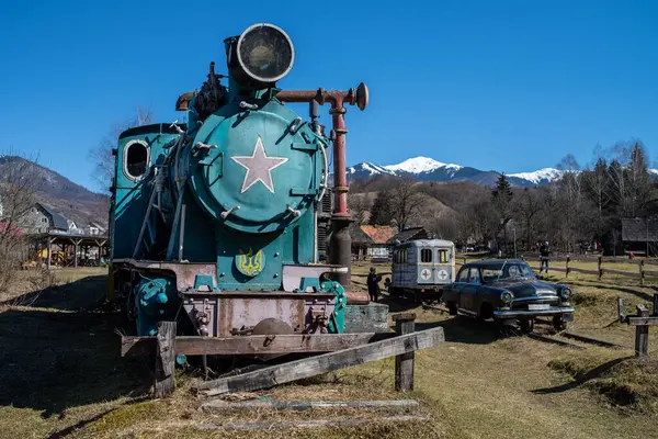 stock image old rusty locomotive on the background of the mountains