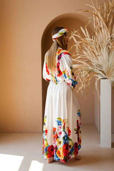 stock image beautiful young woman in a dress with a bag of flowers