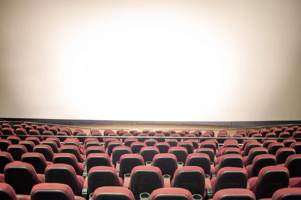 stock image empty cinema theater with red seats and a lot of light