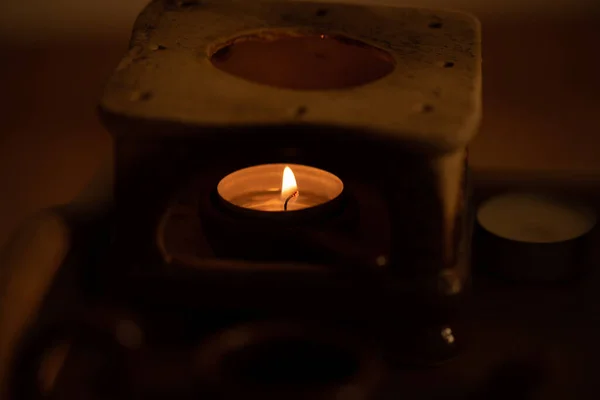 candle in a dark room with a burning candles