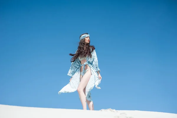 Stock image young beautiful woman in white dress and hat on the beach