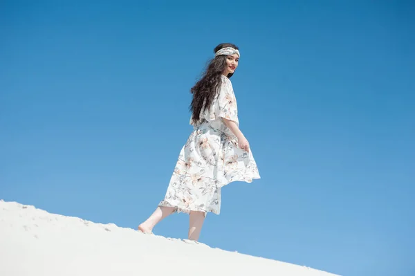 stock image beautiful young woman in a white dress on the beach