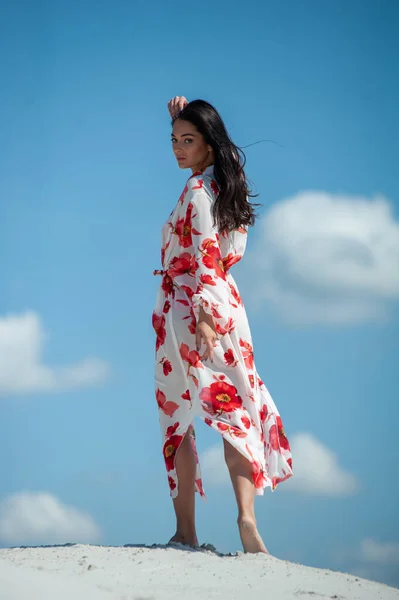 stock image beautiful young woman in a white dress posing on the beach