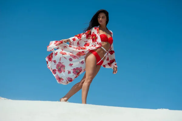 stock image beautiful young woman in a white dress on the beach