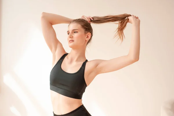 stock image young woman with black hair in sportswear doing exercises in gym