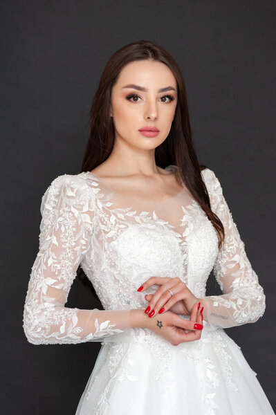 beautiful young woman in white wedding dress with flowers 