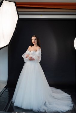 beautiful bride in a white dress in the studio