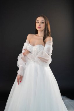 Siyah arka planda beyaz elbiseli güzel bir gelin.