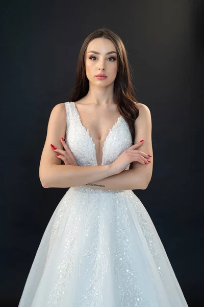 stock image portrait of a beautiful young woman in a wedding dress on a gray background 