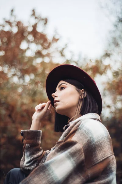 stock image beautiful girl in a cap and jacket posing in autumn park in the fall 