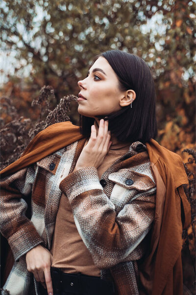 beautiful girl walks in a autumn city park. high quality photo