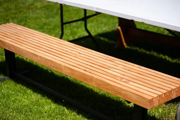 stock image a wooden table with a white tablecloth 