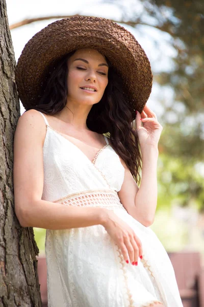 stock image portrait of beautiful young brunette woman wearing summer dress. 