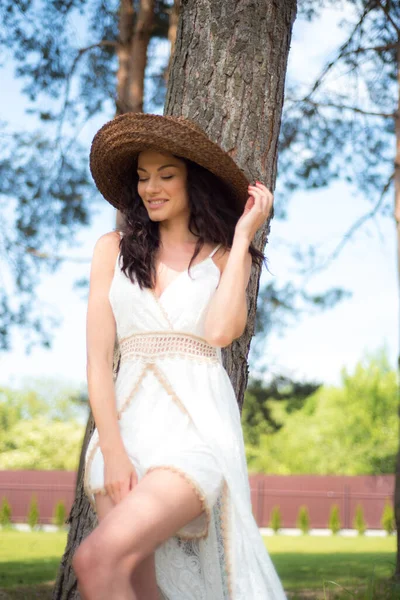 stock image beautiful brunette in a white dress on a summer day 