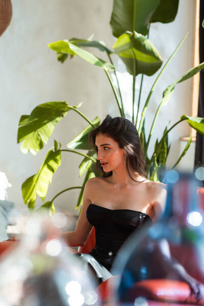 beautiful young woman sitting by the window