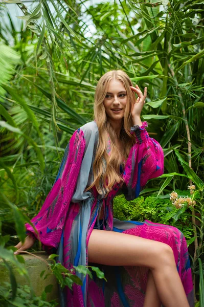 Tropik tatil köyünde yaz kıyafetleri giyen bir kadın.