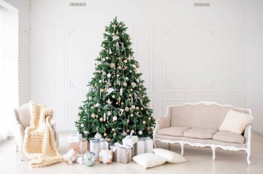 Elegant Christmas interior with a decorated tree in gold and white, wrapped gifts, a vintage beige sofa, and an armchair with a cozy knit blanket. Bright white walls create a festive, minimalist ambiance clipart