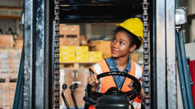 Portrait of a female worker with a forklift in the warehouse., Industrial and industrial concept.